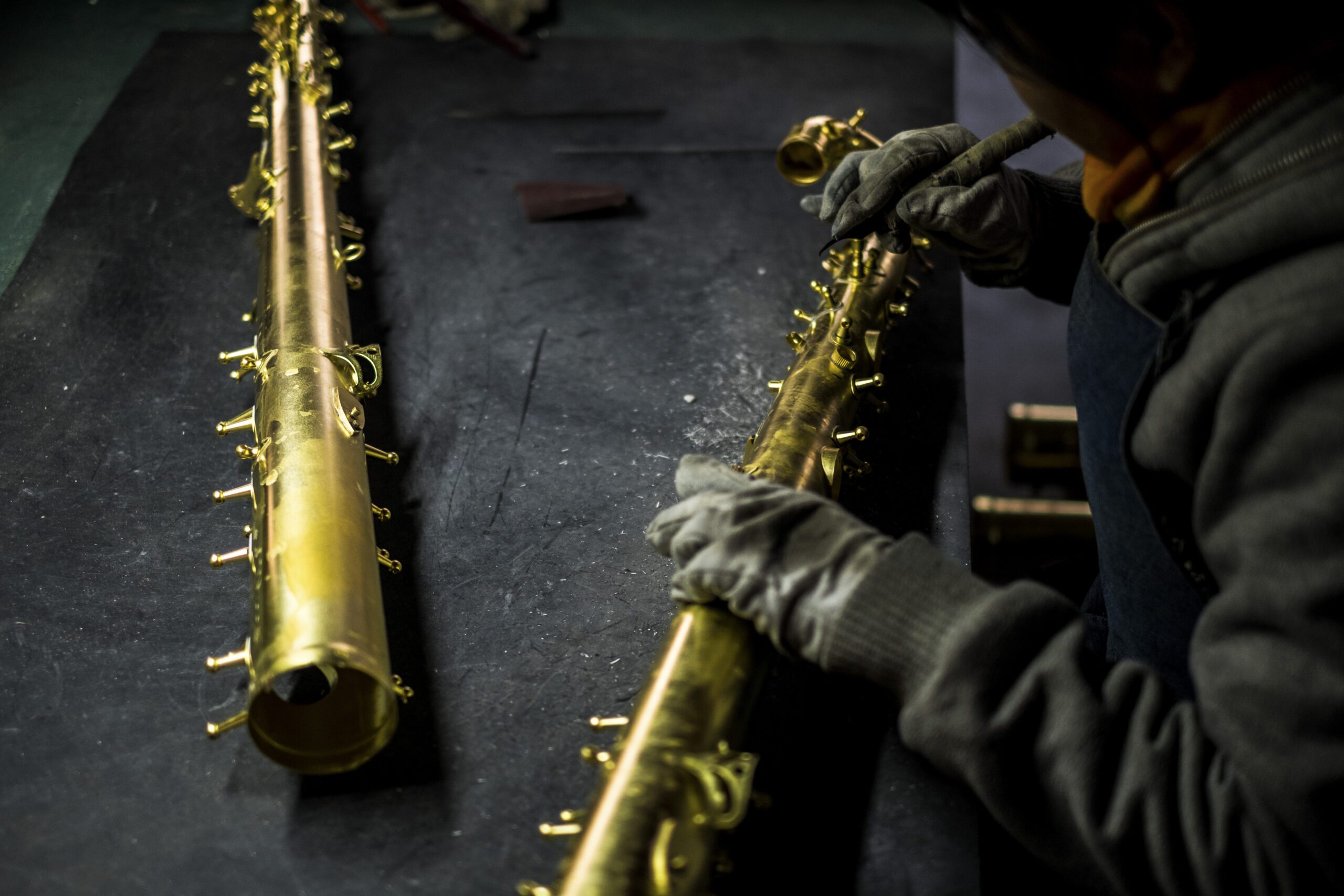 A factory worker polishes saxophone parts in Sidangkou, China.